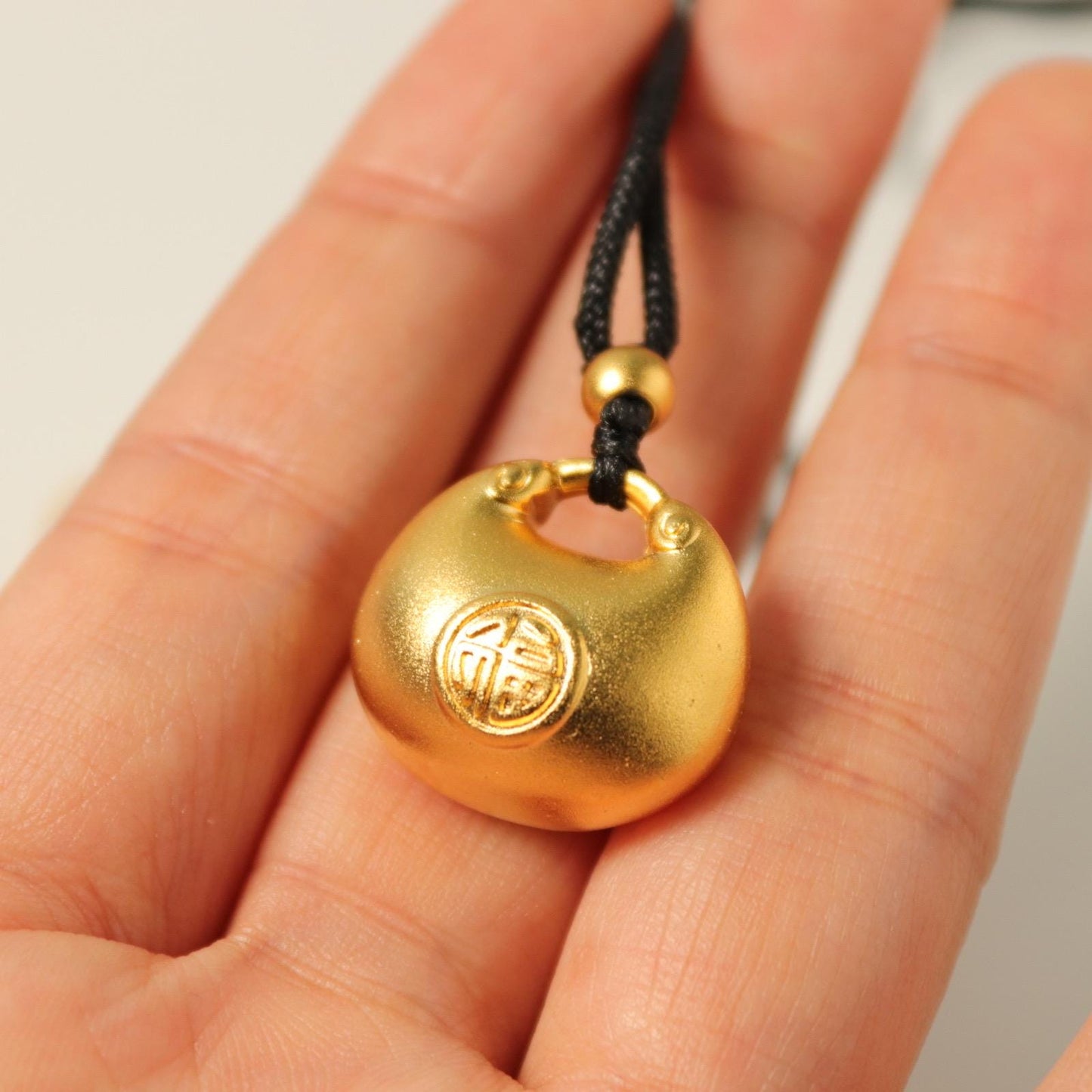 24K gold blissful lock pendant
