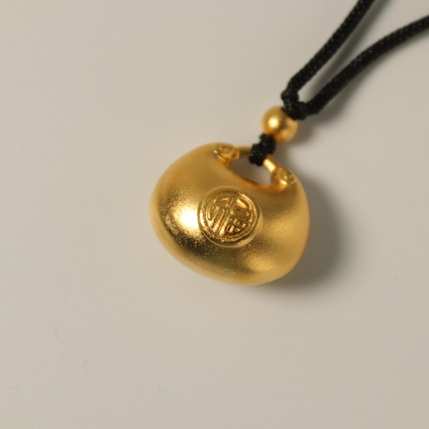 24K gold blissful lock pendant