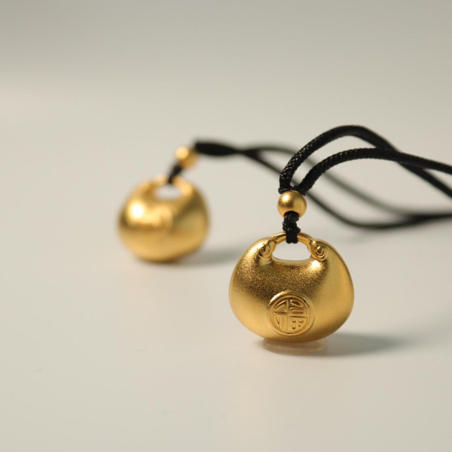 24K gold blissful lock pendant
