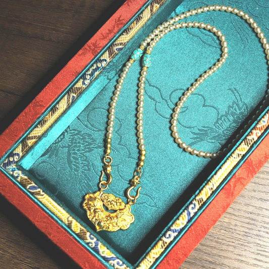 Traditional Chinese longevity lock pendant with faux pearl necklace