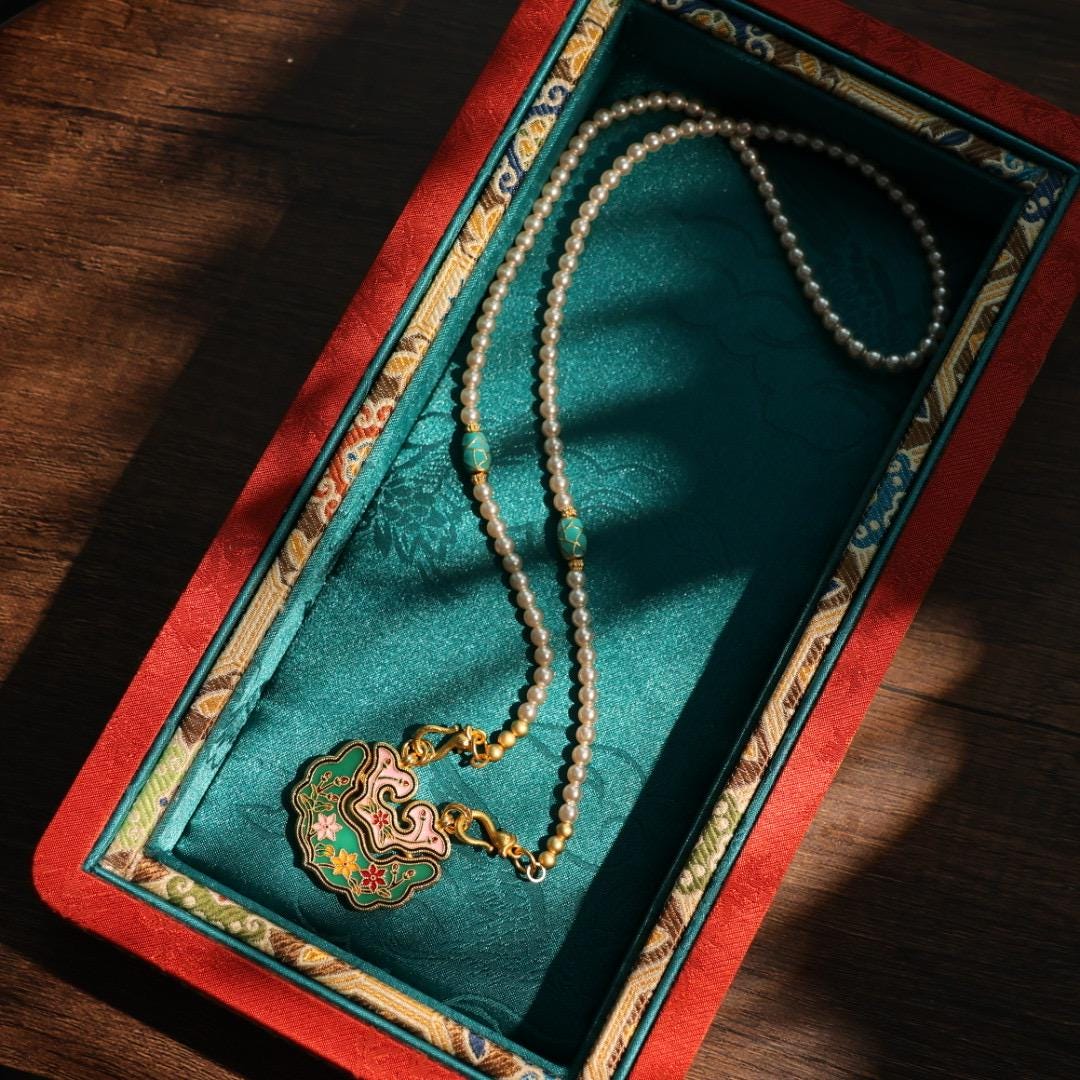 Traditional Chinese longevity lock pendant with faux pearl necklace