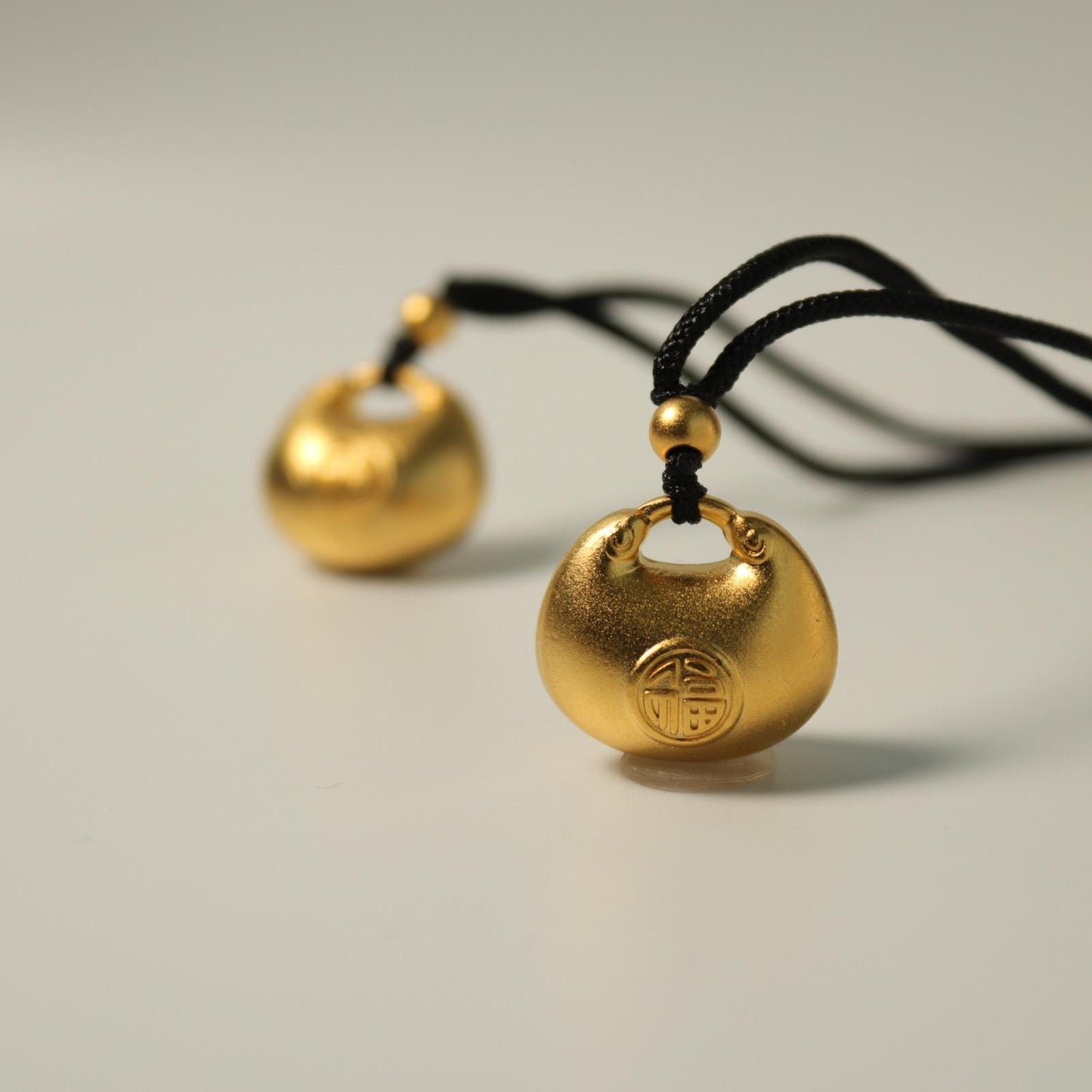 24K gold blissful lock pendant
