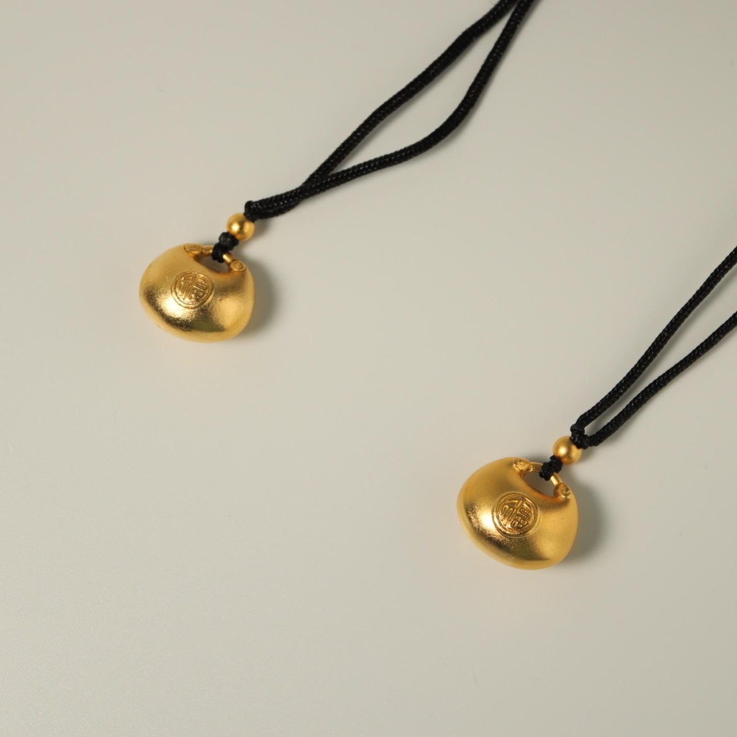 24K gold blissful lock pendant