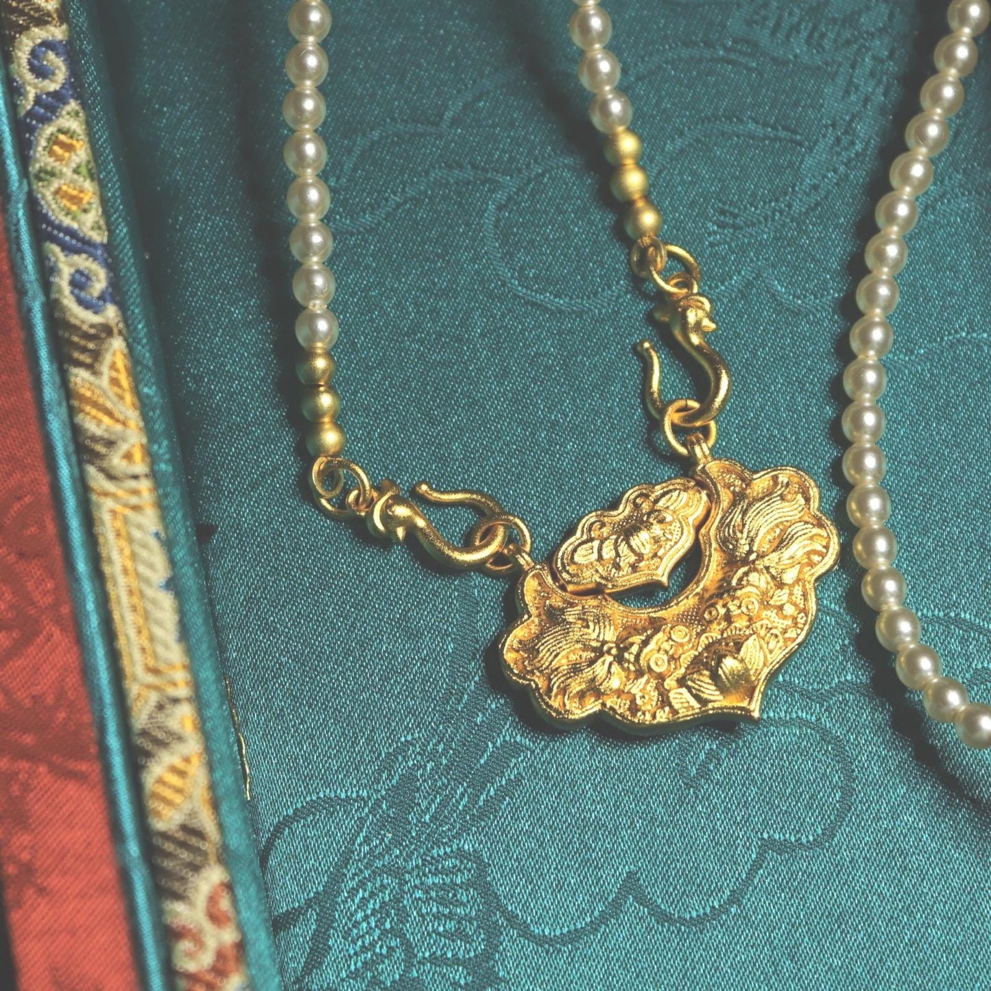 Traditional Chinese longevity lock pendant with faux pearl necklace